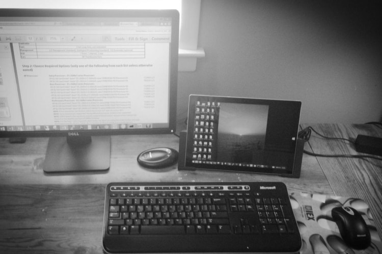 Surface Pro 3 on desk near keyboard and monitor