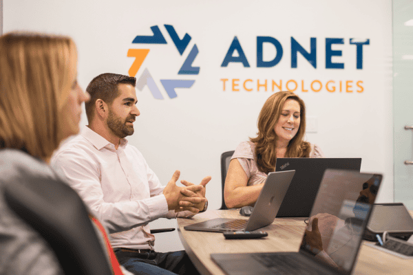 ADNET team discussing IT services
